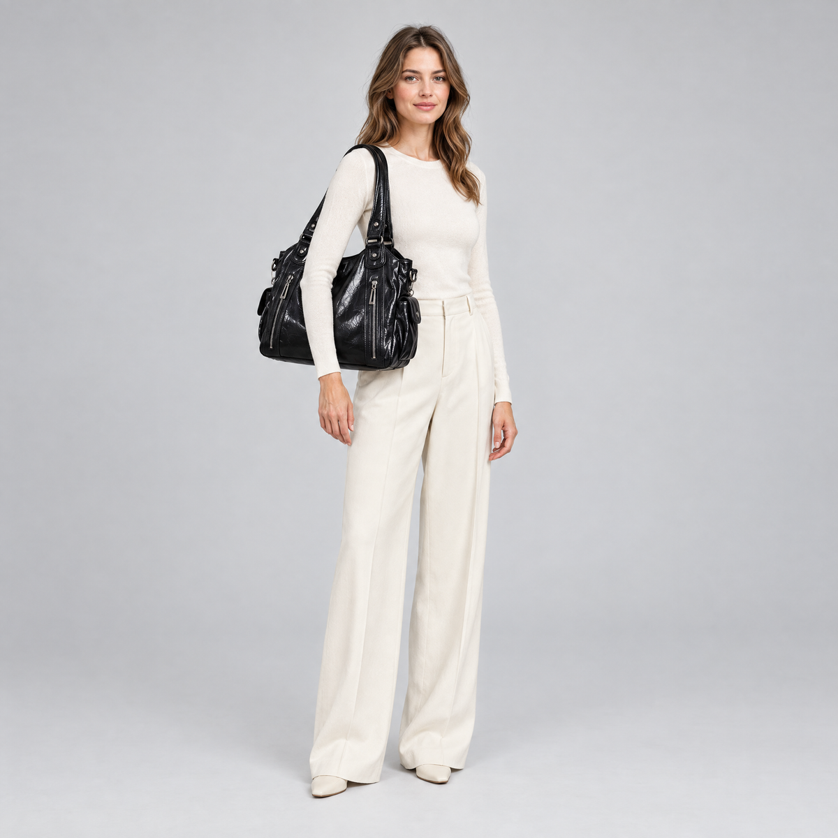 Marlowe soft carry shoulder bag in black worn on the shoulder